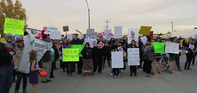 About 100 people spent the evening protesting Stephen Harper during the Conservative leader's Saskatoon campaign stop.