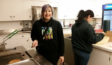 Chantelle Charles flips pancakes for the Nothern Spirits fundraiser. Photo by Chelsea Laskowski