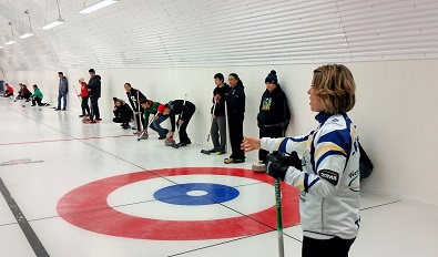 Stefanie Lawton gies some curling lessons in Ile a la Crosse. Photo by Chelsea Laskowski