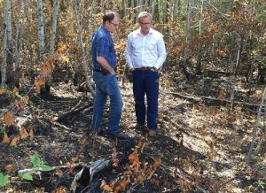 Premier Brad Wall looks at the damage after the summer's wildfires.