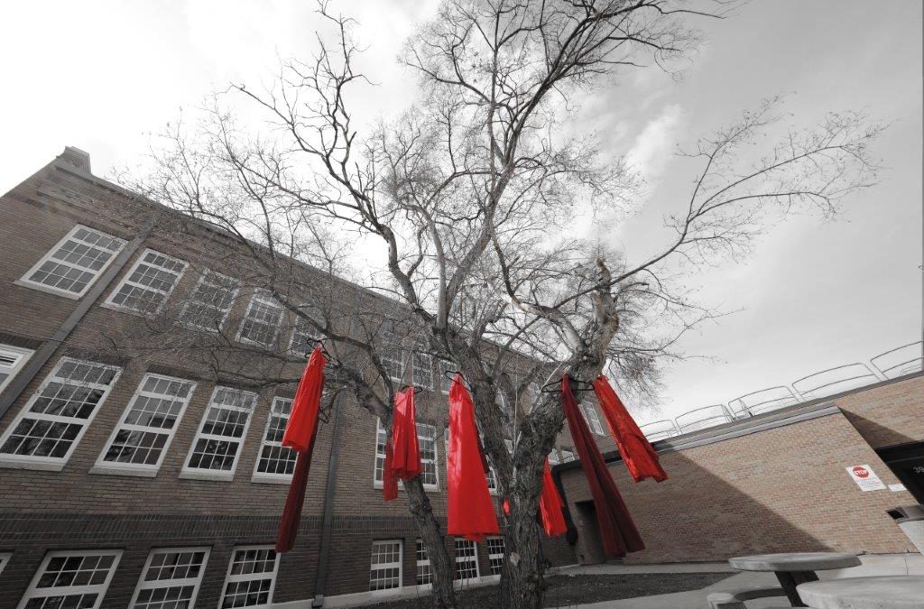 Sask. Polytechnic honours Missing and Murdered Indigenous Women and Girls with red dress displays