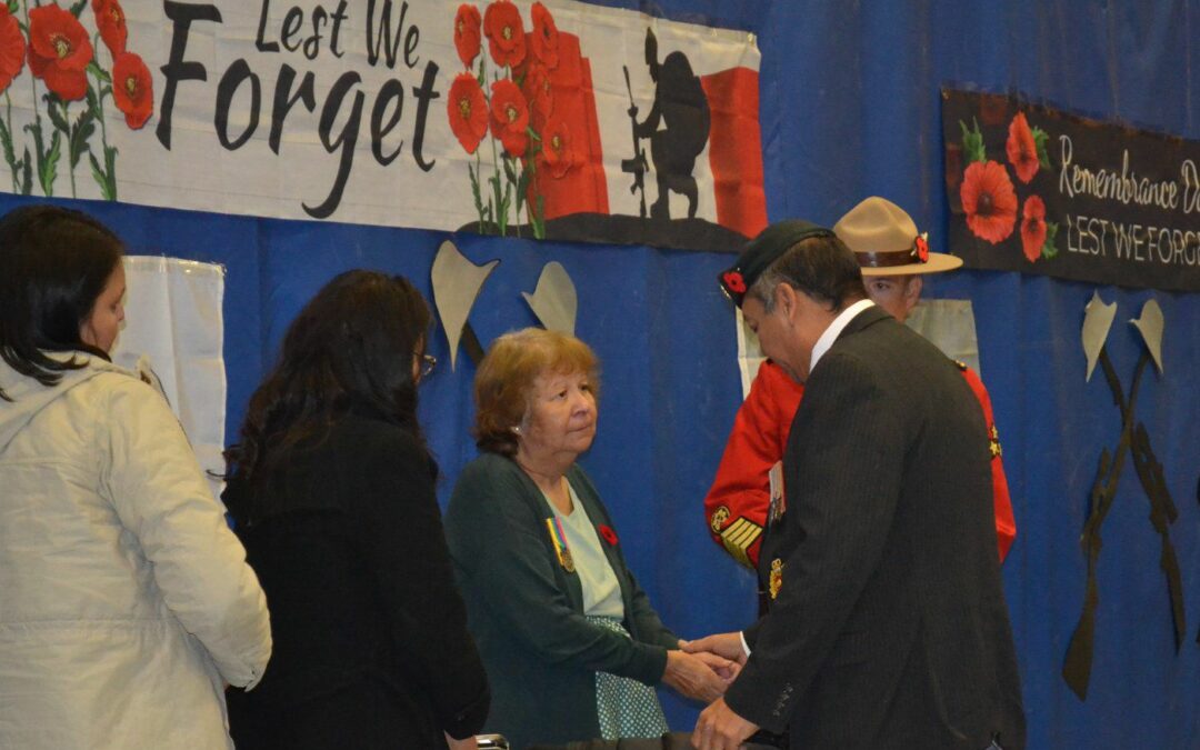 Wife of Veteran slain in James Smith tragedy honoured with medal and Silver Cross during PAGC Remembrance Day service